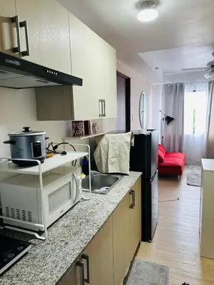 a kitchen with a sink and a refrigerator at Tower C 3rd Floor in Taytay
