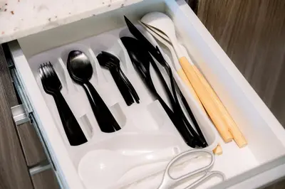 a plastic tray with utensils in a drawer at Cozy 1BR Condo in McKinley West in Manila