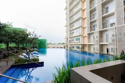 a swimming pool in the middle of a building at Cozy 1BR Condo in McKinley West in Manila