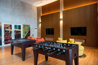 a living room with a table and a chess board at Cozy 1BR Condo in McKinley West in Manila