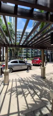 a car parked in a parking lot next to a building at Rqui Condotel Rooms Near Airports and Newport World Casino in Manila