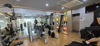 a gym with a bunch of equipment in a room at Rqui Condotel Rooms Near Airports and Newport World Casino in Manila