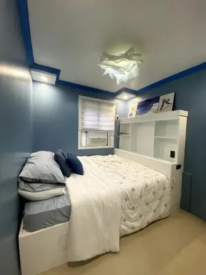 a bedroom with a bed with a shark on the ceiling at The Blue Unit - By H&A in Manila