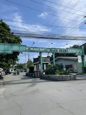 a bridge over a street with a sign for a pharmacy at The Blue Unit - By H&A in Manila