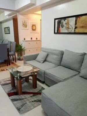 a living room with a couch and a table at Sweet Condo in Manila