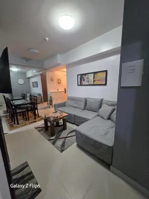 a living room with a couch and a table at Sweet Condo in Manila
