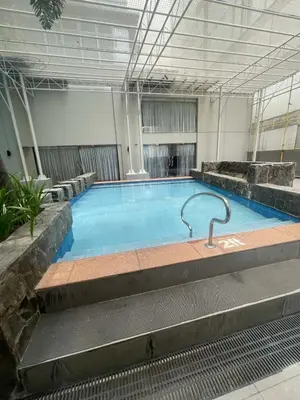a large swimming pool in a building at Antel Spa Residences 1908 in Manila