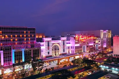 a city lit up at night with purple lights at Naia T3 Condotel in Manila