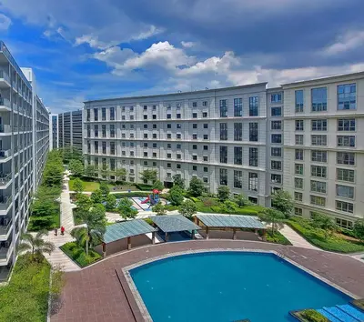 an overhead view of a large building with a swimming pool at Naia T3 Condotel in Manila