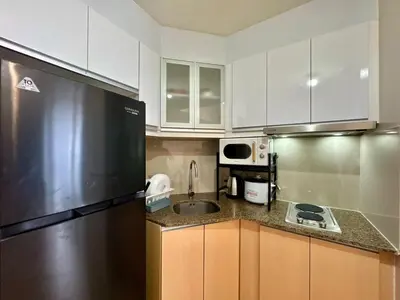 a kitchen with a stainless steel refrigerator and a sink at Naia T3 Condotel in Manila