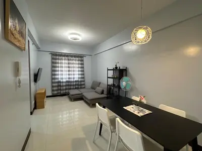 a living room with a table and a couch at Newport City Home- Naia T3 in Manila