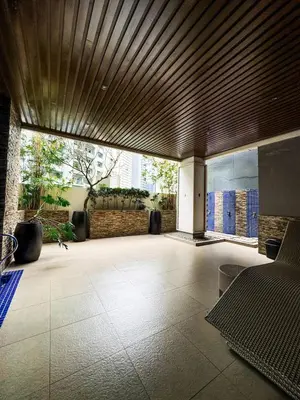 a large lobby with a large wooden ceiling at Convertible Solo Budget Studio in Salcedo Village in Manila