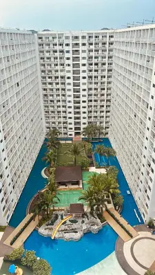 an aerial view of a resort with tall buildings at 7 Mins from MOA Comfy Stay with Pool View and WiFi in Manila