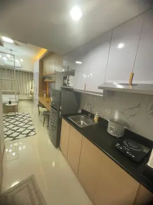 a kitchen with a sink and a counter top at Field residences Building 9 in Manila