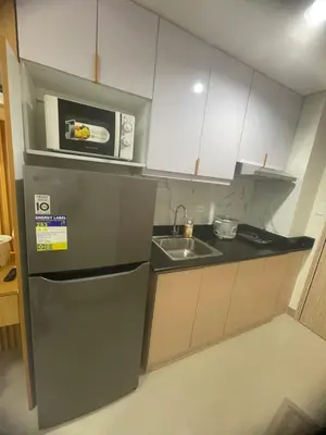 a kitchen with a stainless steel refrigerator and a microwave at Field residences Building 9 in Manila