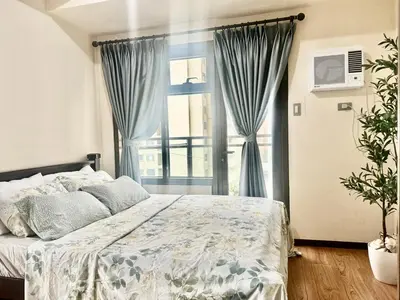 a bedroom with a bed and a large window at Luxurious Haven in the Sky in Manila