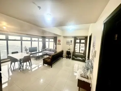 a living room with a couch and a table at Luxurious Haven in the Sky in Manila