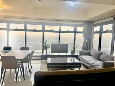 a living room with a couch and a table at Luxurious Haven in the Sky in Manila