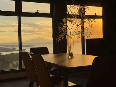 a table with chairs and a vase with a plant at Luxurious Haven in the Sky in Manila