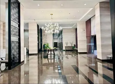 a large lobby with a chandelier in a building at Luxurious Haven in the Sky in Manila