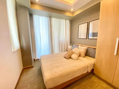 a bedroom with a bed and a large window at Leisure escape staycation Azure in Manila