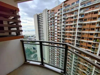 a balcony with a view of some tall buildings at Manila Bay View - 1BR with balcony in Manila