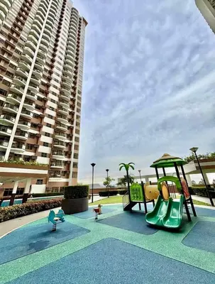 a playground in front of a large apartment building at Manila Bay View - 1BR with balcony in Manila