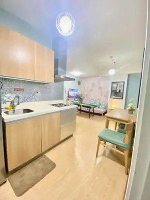 a kitchen with a sink and a table in a room at Leisure escape Azure staycation in Manila