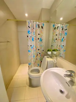 a bathroom with a toilet and a sink at Leisure escape Azure staycation in Manila