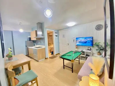 a living room with a ping pong table in it at Leisure escape Azure staycation in Manila