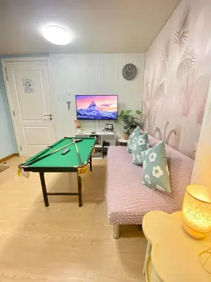 a living room with a pool table and a couch at Leisure escape Azure staycation in Manila