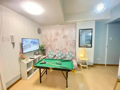 a living room with a pool table in it at Leisure escape Azure staycation in Manila