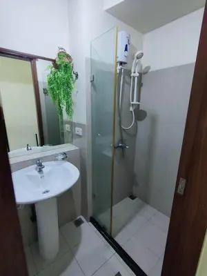 a bathroom with a shower and a sink at The Catalina at The Beacon Makati in Manila