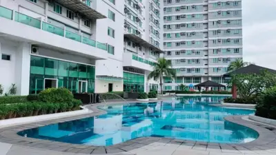 a swimming pool in front of a building at The Catalina at The Beacon Makati in Manila