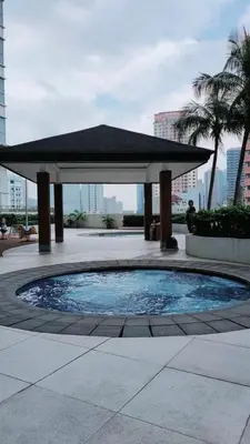 a gazebo with a pool in a courtyard at The Catalina at The Beacon Makati in Manila