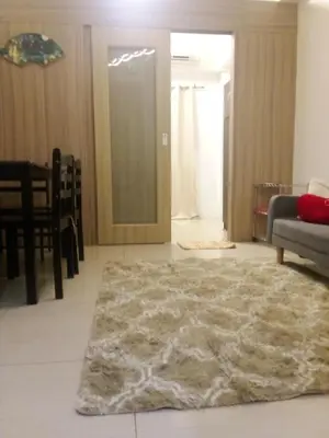 a living room with a furry rug on the floor at Lynx staycation in Manila