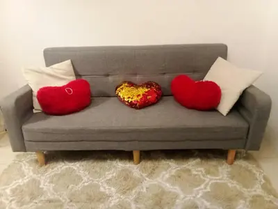 three heart cushions sitting on a couch at Lynx staycation in Manila