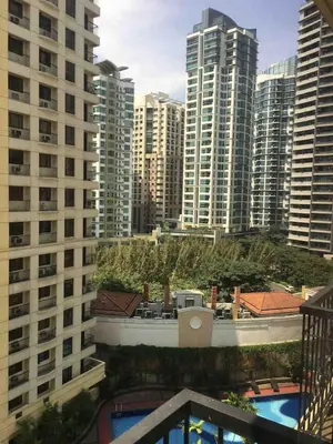 a view of a city with tall buildings at Rustic 1 BR Apartment Poolside View in Manila