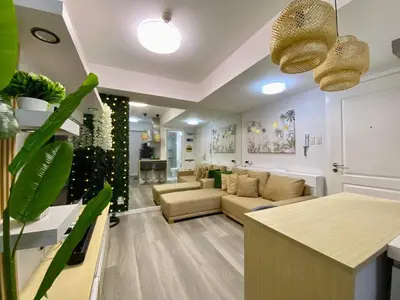 a living room with a couch and a table at Leisure escape Azure in Manila