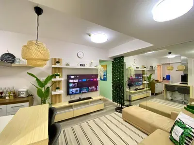 a living room with a couch and a tv at Leisure escape Azure in Manila