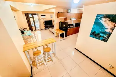 a kitchen and living room with a table and chairs at The Radiance Manila bay 2BR in Manila