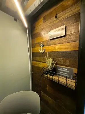 a room with a wooden wall with a sign on it at Seaside Sanctuary and Beach Vibes in Manila