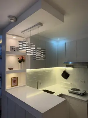a kitchen with a white counter and a sink at BnJ Suite Urban Deca w Netflix, Max, YT Premium, FREE parking in Manila