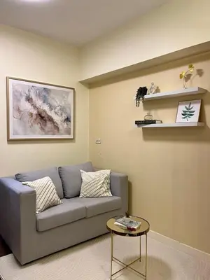 a living room with a couch and a table at Condo in Pasay 12th flr studio unit-near MOA, PICC in Manila