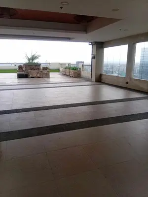 an empty room with a large room with tables and windows at Condo in Pasay 12th flr studio unit-near MOA, PICC in Manila