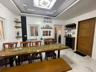 a kitchen with a large wooden table and chairs at Casa MiKulai