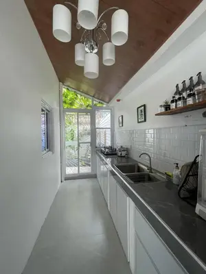 a kitchen with white walls and a ceiling at Casa MiKulai
