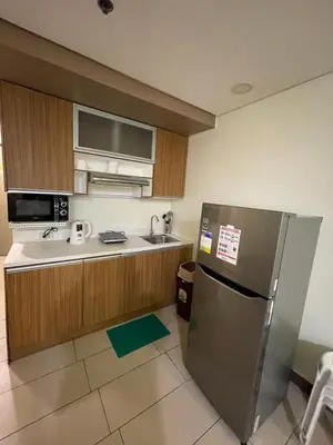 a kitchen with a stainless steel refrigerator and a sink at Antel Spa Residences 7OB in Manila