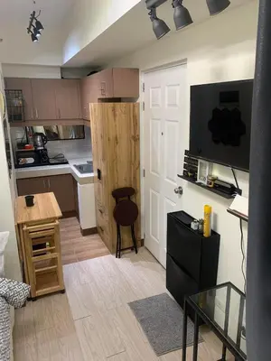 a small kitchen with a door and a table at EK's Place in Manila