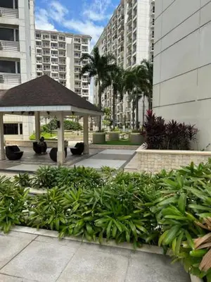 a garden with a gazebo in a city at Solemare Parksuites with balcony in Manila